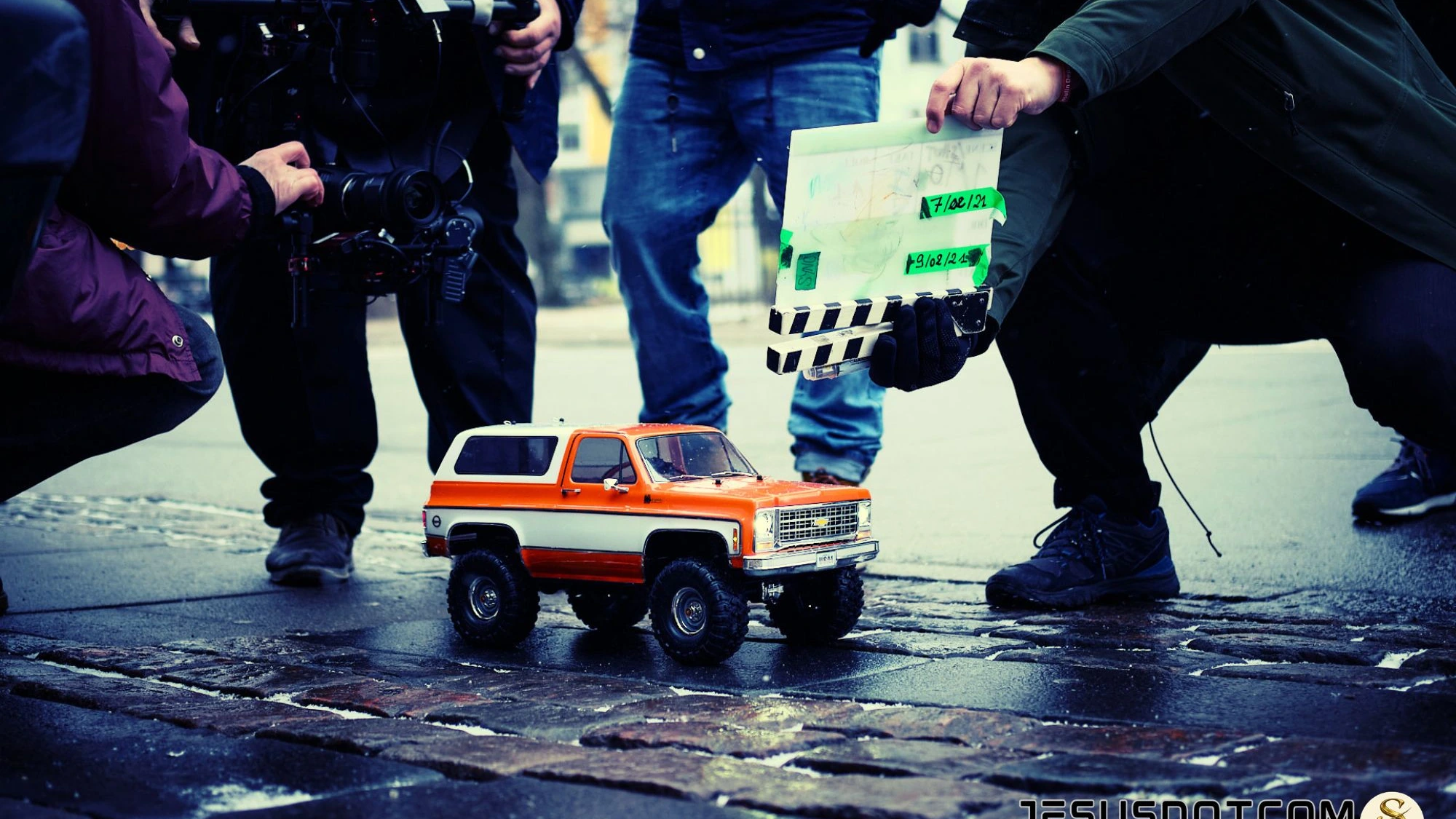 Behind the scenes of JESUSDOTCOM — camera crew, clapperboard and miniature truck